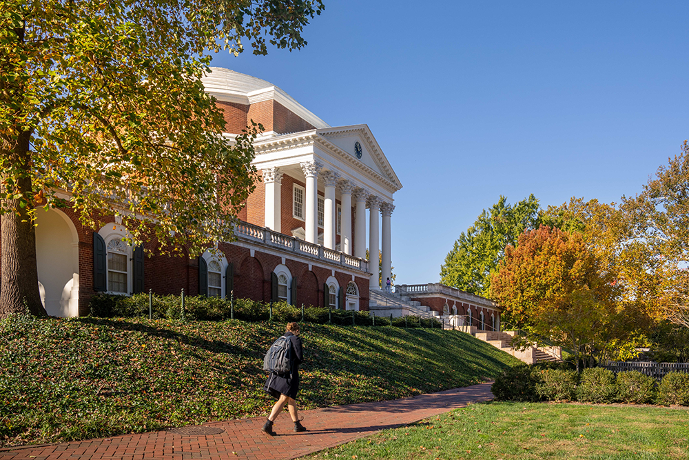 UVA Rotunda with Fall Leaves and Student on Sidewalk