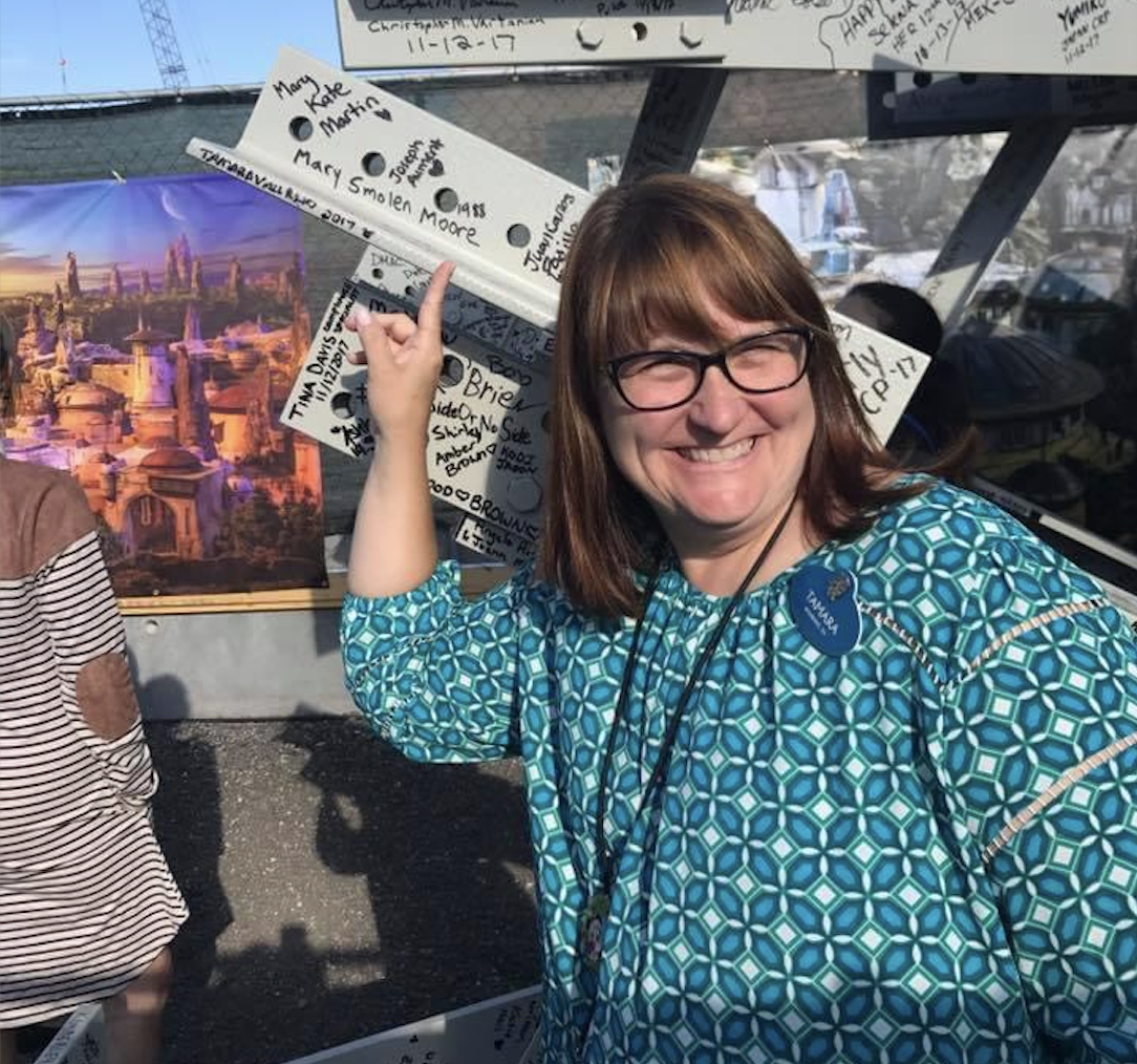 Tammy Vallario pointing at her signature at Disney World's Star Wars: Galaxy's Edge Park