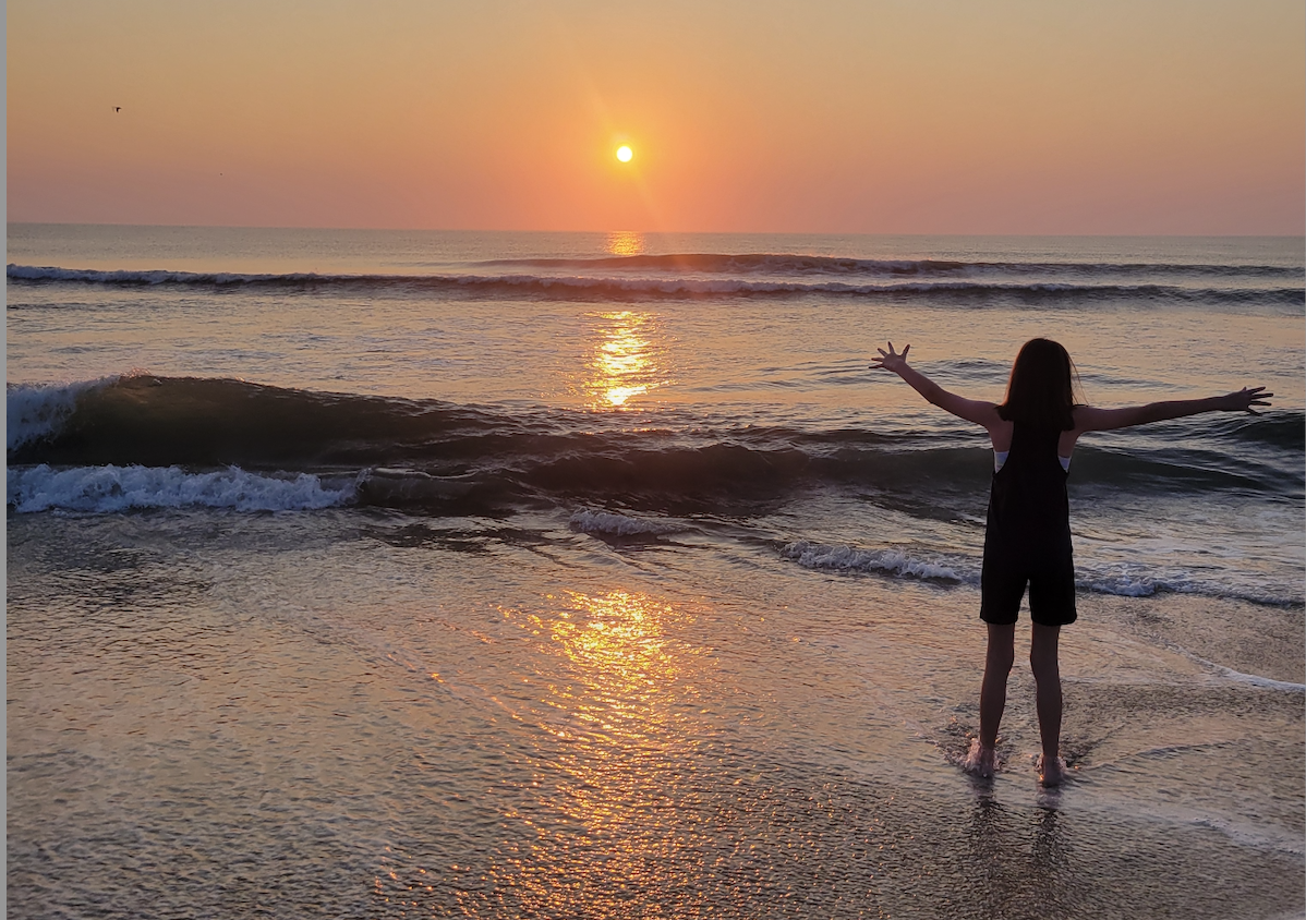 Trinity Leahy Faces the Sunrise at the Ocean