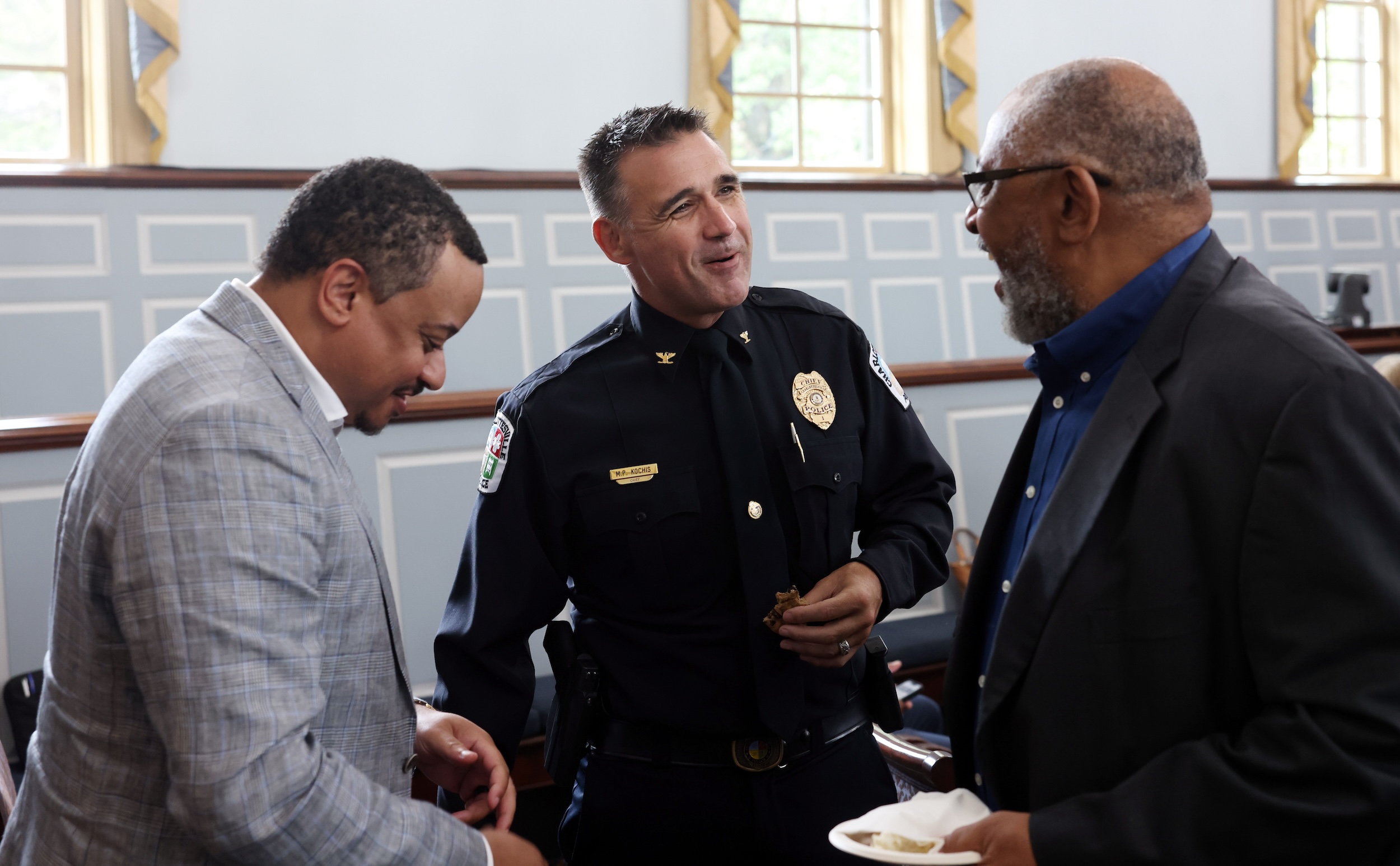 Men in uniform and suits talking