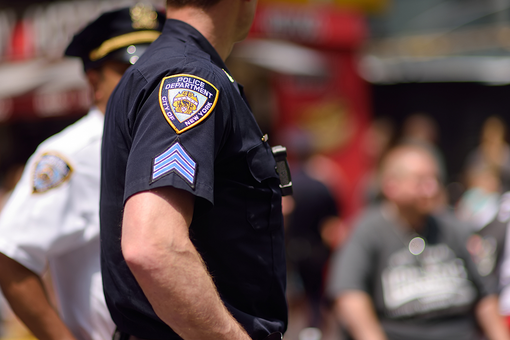 police officer stands in crowd