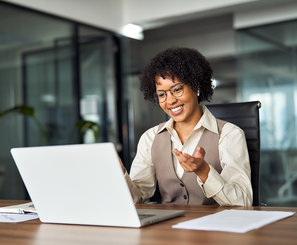 Woman smiling at computer at work