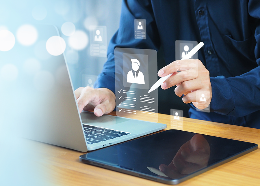 person on computer with visual indication of high-tech personal information software